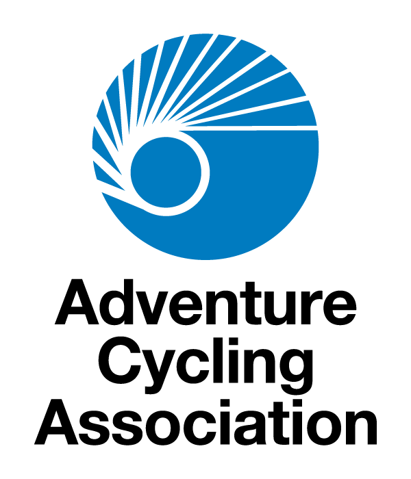 Adventure Cycling Association Logo, blue circle with spokes 