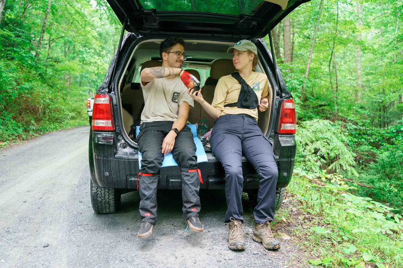 "Volunteer EMS taking a break, sitting at the back of a car."