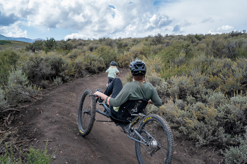 "Amanda and Zoey riding on a dirt trail"