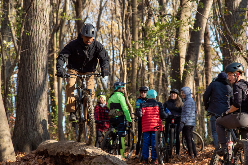 "Anson on his bike balancing on a log"