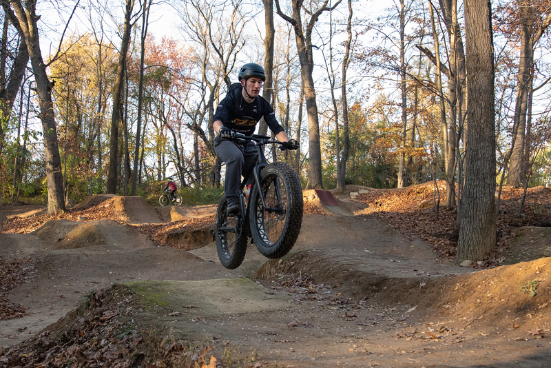 "Mountain biker on a fat bike riding the Cunningham jump park"