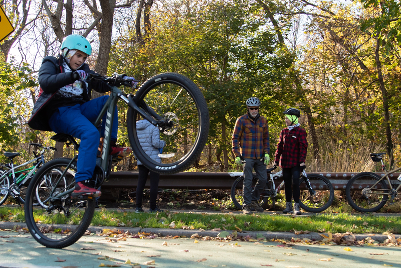 "Kid practicing a wheelie"