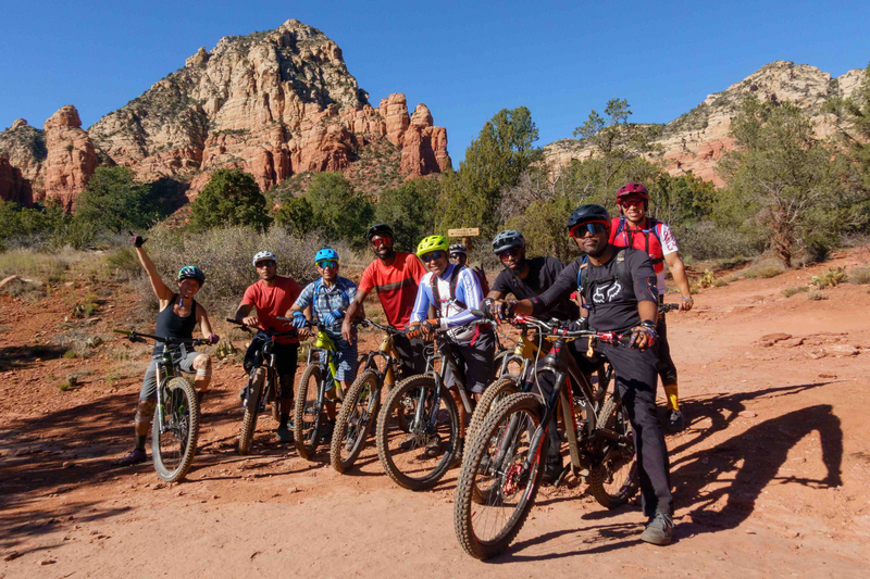"Group of mountain bikers in a desert setting"