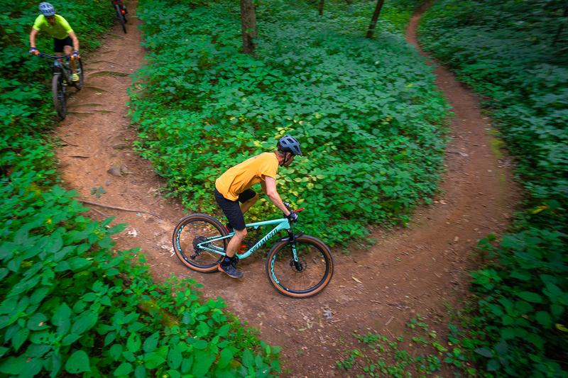 "Two mountain bikers turning on a trail in Bristol, VA"