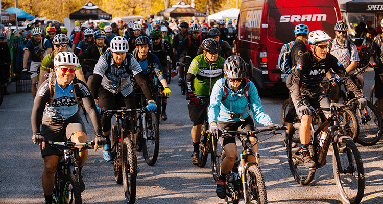 bike riders proceed toward the camera