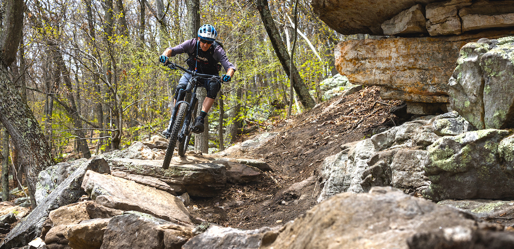 Person riding a rock feature in Cacapon on a NICA race course in Berkley Springs, WV - a Trail Accelerator Grant awardee