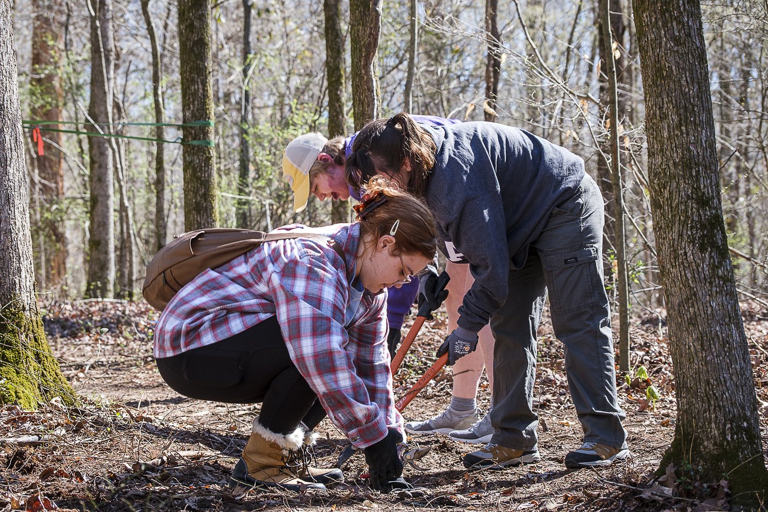 Three volunteers working on maintaining their community trails in Florence, AL.