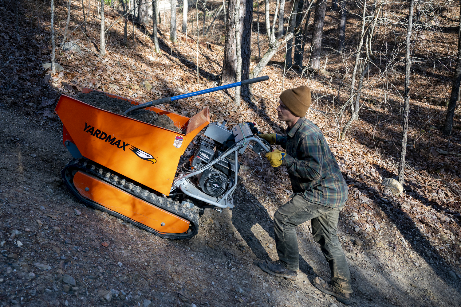 "Northwoods Trails Specialist Jake Meredith pushes a material buggy along a flow trail. "