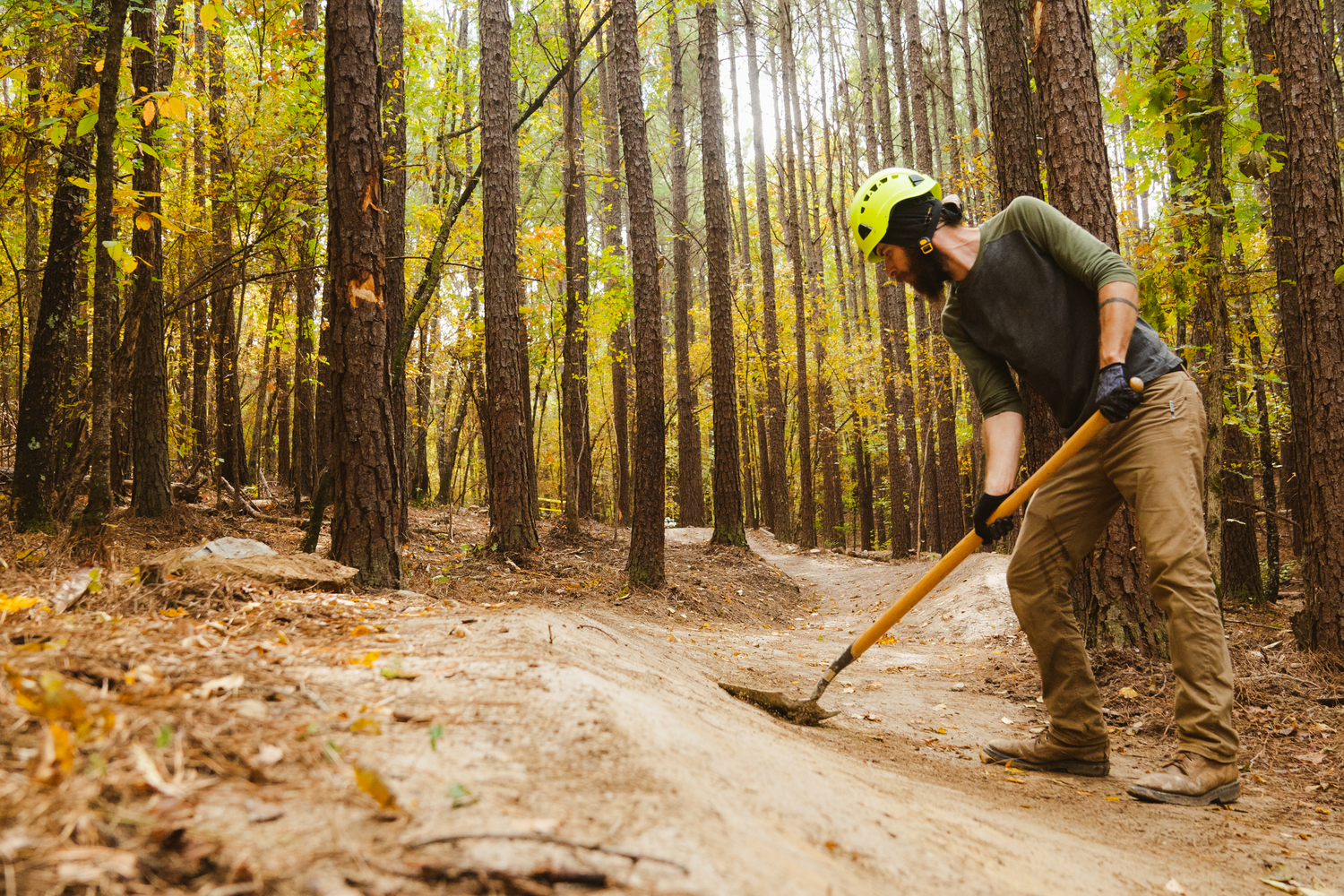 Former IMBA Trail Solutions' Trail Specialist Chris Lane hand finishing features in Northwoods.