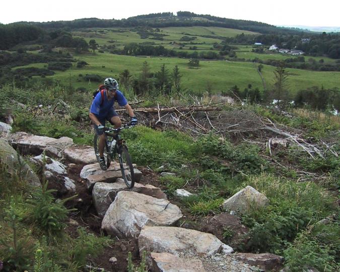 Rich Edwards, IMBA Trail Solutions, UK, boulder causeway, DLBT, Dalbeattie, Scotland, rock formation, hillside, mountain bikes
