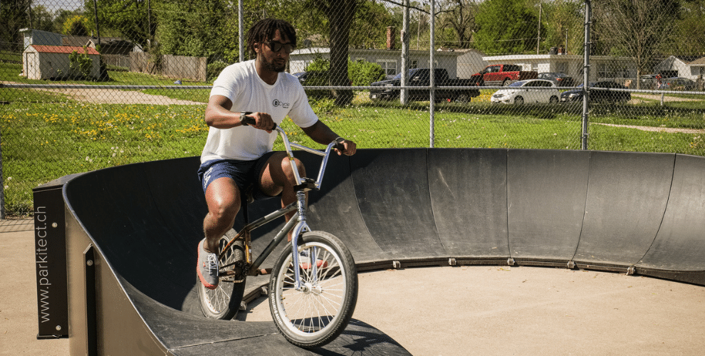 Person riding BMX bike on Upland Pump Track in Omaha, Nebraska. 