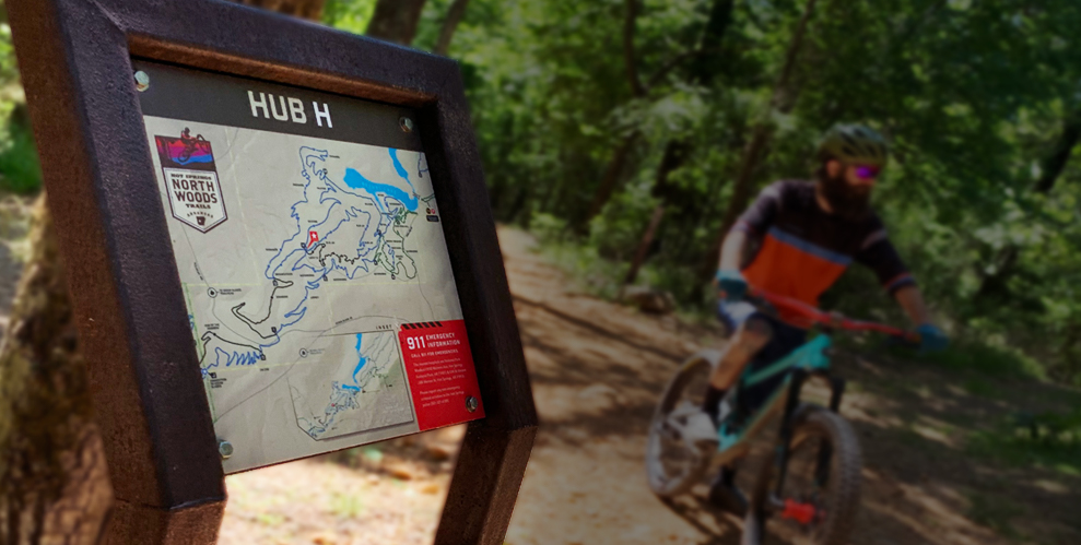 Hub sign with mountain biker in background, Hot Springs AR