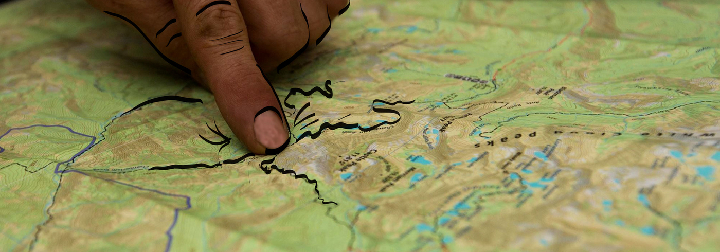 finger pointing at trail system map
