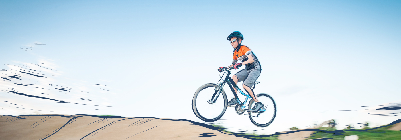 IMBA For Youth banner. Child on bike, riding over wooden feature. 