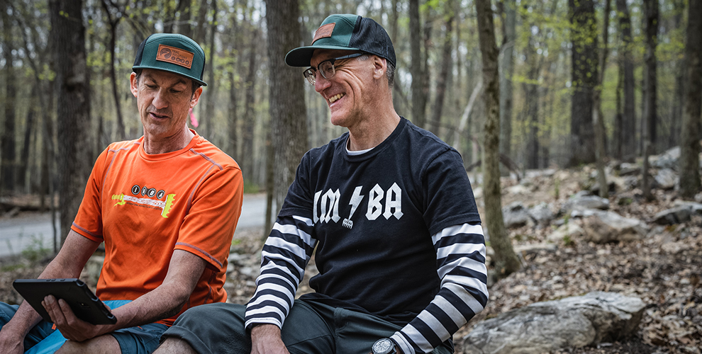 Joey Klein (left) and Chris Orr look over a trail design together at Cacapon Resort State Park.