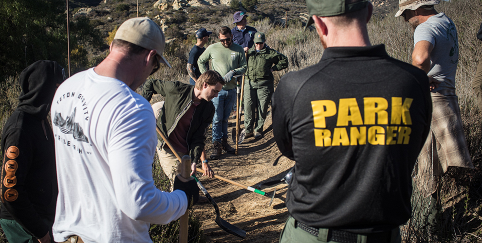 Group of land managers learning about nicks during an IMBA Trail Management School.