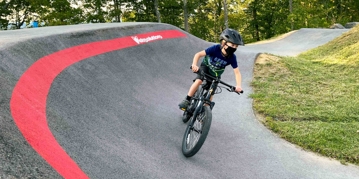 Kid in riding in an asphalt pumptrack