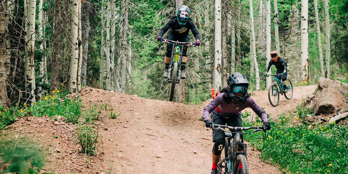 Women riding a jump line.