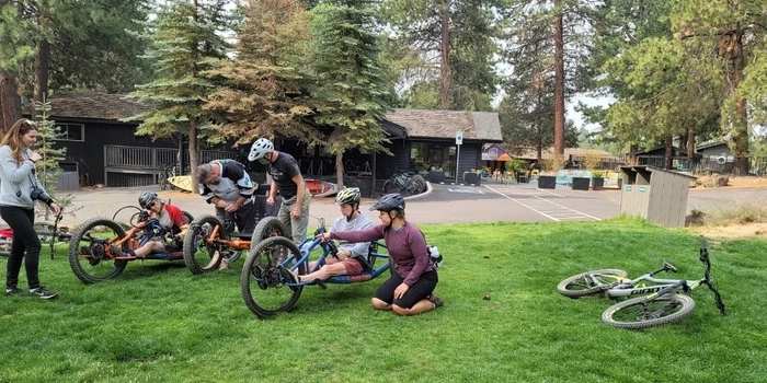 Group of adaptive riders reviewing bikes and gear in Oregon 