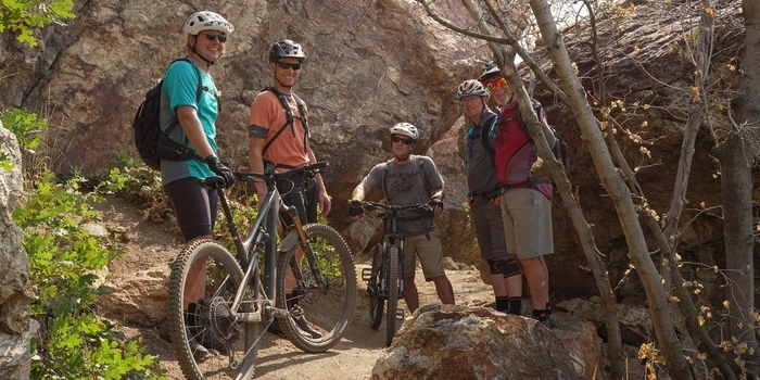 Five mountain bikers, members of IMBA's singletrack society, take a shade break on a group ride in Draper, Utah