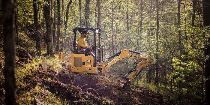 IMBA trail solutions machine operator on excavator building new trail