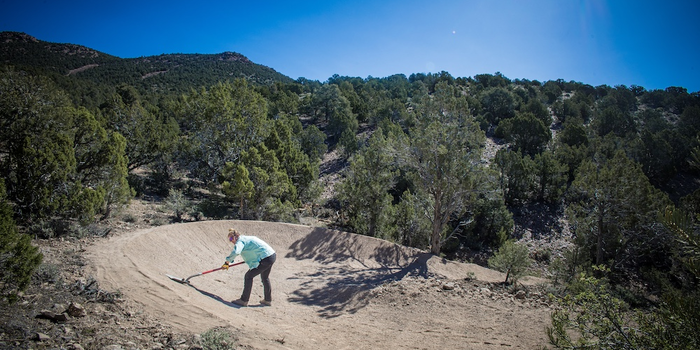 IMBA Trail Solutions staff constructing berm on trail in Pioche, NV.