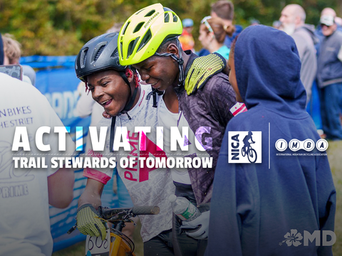 Young, BIPOC NICA athletes sweating and talking after a race in full mountain biking gear. 