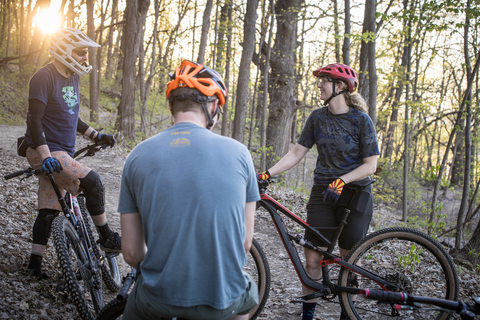 Three riders pause in a hardwood forest of Winona, MN.