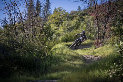 Ashland Devo coach hugs into a berm while riding MOTR