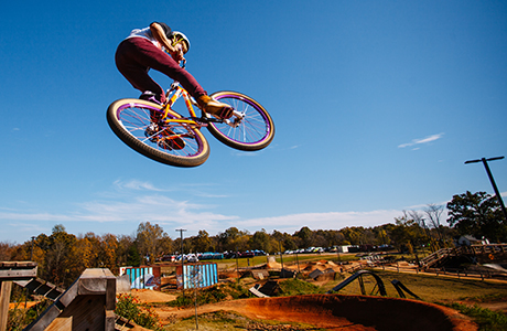 Person in air on dirt jump bike