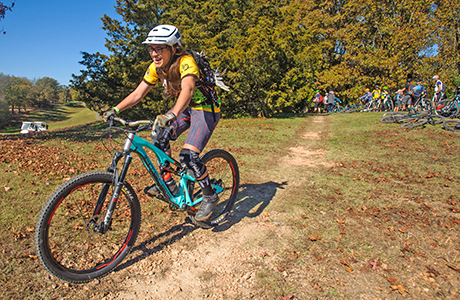 Person riding mountain bike in a workshop