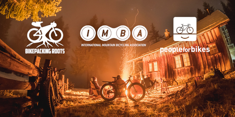 campfire outside of cabin orogenesis bikepacking with BOLT coalition org logos