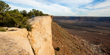 A mountain biker rides on southwestern single track in a desert environment.|