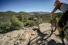 adam and brice ride down a desert trail