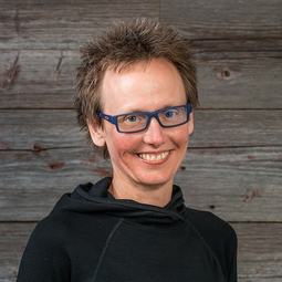 wearing blue glasses and a black shirt