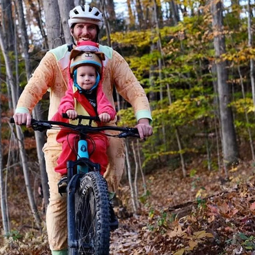 Phil riding with his toddler.