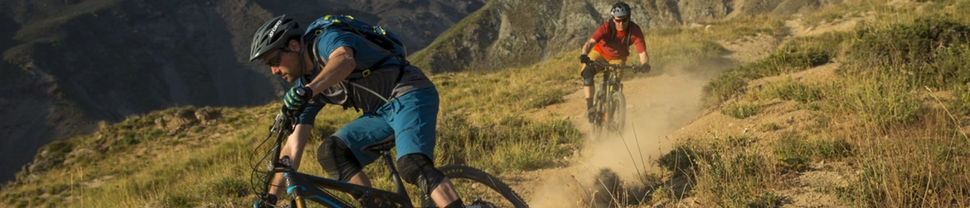 Two male mountain bikers riding downhill in Chile.